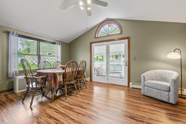 8 Grovemount Ln, Lewiston, ME 04240 - dining room with a baseboard radiator, vaulted ceiling, a ceiling fan, wood finished floors, and plenty of natural light