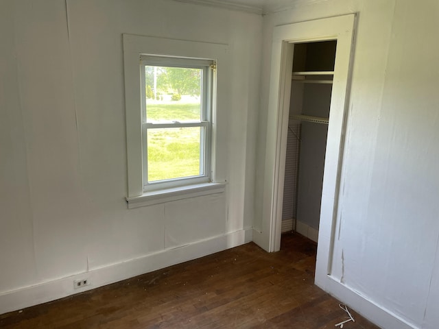 1431 Indian River Rd, Addison, ME 04606 - unfurnished bedroom with dark wood-type flooring, a closet, and multiple windows