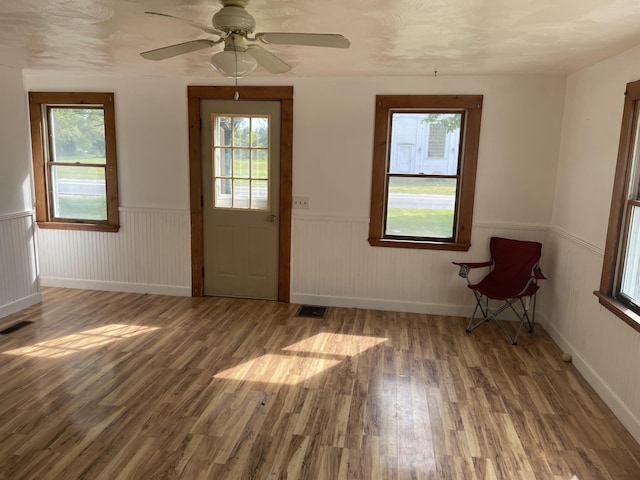 1431 Indian River Rd, Addison, ME 04606 - entrance foyer with wainscoting, wood finished floors, and ceiling fan