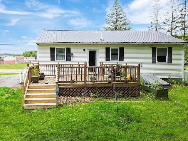 154 Rideout Ave, Lewiston, ME 04240 - rear view of house with a metal roof, a lawn, and a deck