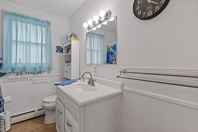 154 Rideout Ave, Lewiston, ME 04240 - bathroom featuring a baseboard heating unit, vanity, and tile patterned floors