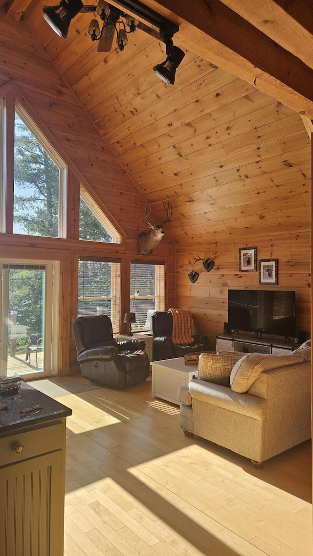 67 Upper Narrows Rd, Long Pond Twp, ME 04945 - living area featuring high vaulted ceiling, wood walls, a wood ceiling with exposed beams, and light wood finished floors