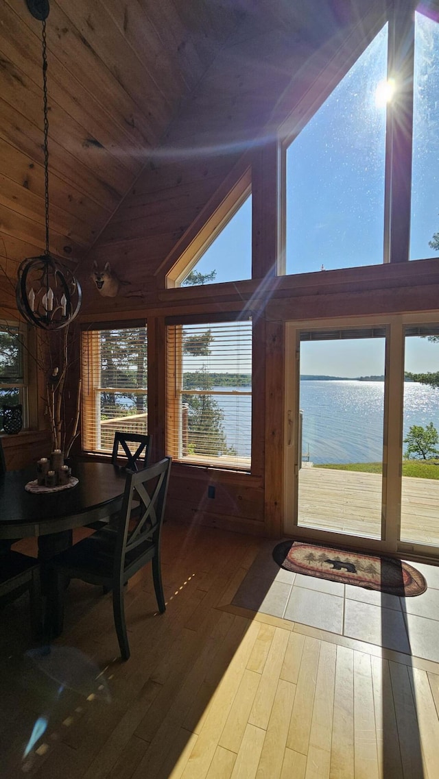 67 Upper Narrows Rd, Long Pond Twp, ME 04945 - dining room with wood ceiling, hardwood / wood-style flooring, a water view, vaulted ceiling, and a chandelier