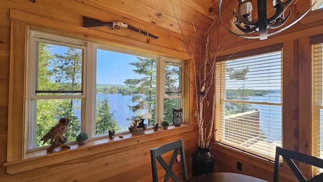67 Upper Narrows Rd, Long Pond Twp, ME 04945 - dining room with a water view, wooden walls, and vaulted ceiling
