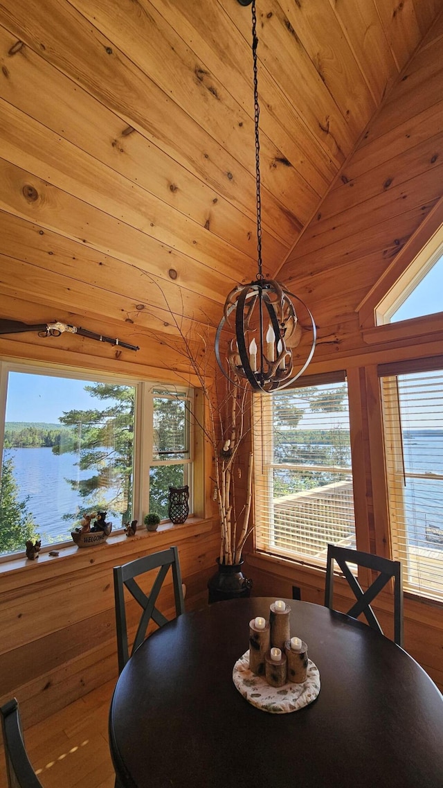 67 Upper Narrows Rd, Long Pond Twp, ME 04945 - dining room featuring a chandelier, lofted ceiling, wood ceiling, wooden walls, and a water view