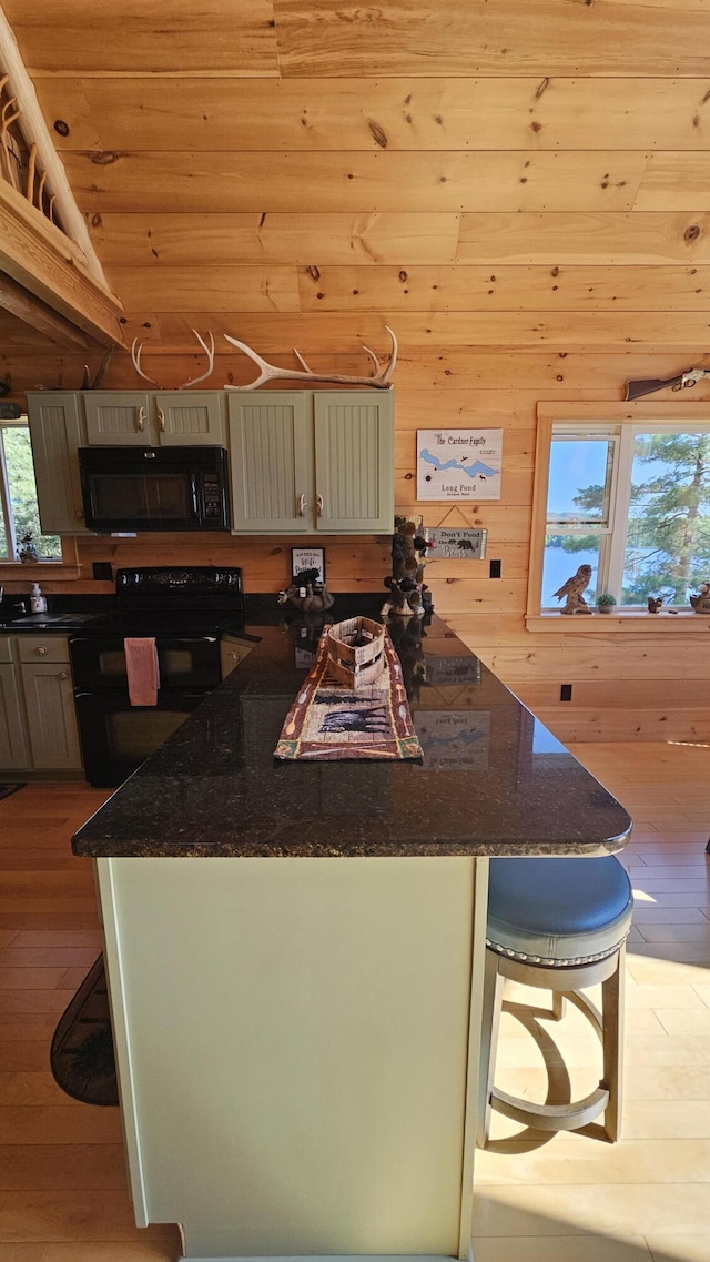 67 Upper Narrows Rd, Long Pond Twp, ME 04945 - kitchen featuring black appliances, hardwood / wood-style flooring, wood ceiling, a breakfast bar, and a center island