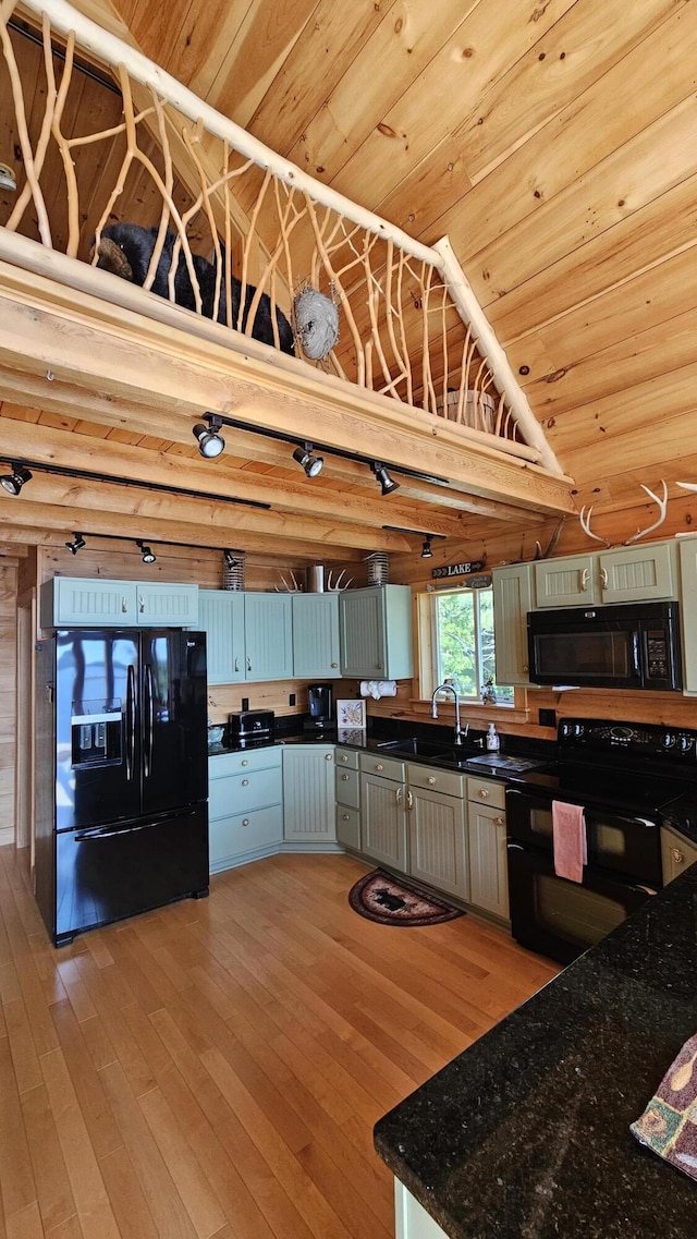 67 Upper Narrows Rd, Long Pond Twp, ME 04945 - kitchen featuring black appliances, light wood-style flooring, vaulted ceiling, wooden ceiling, and dark stone countertops
