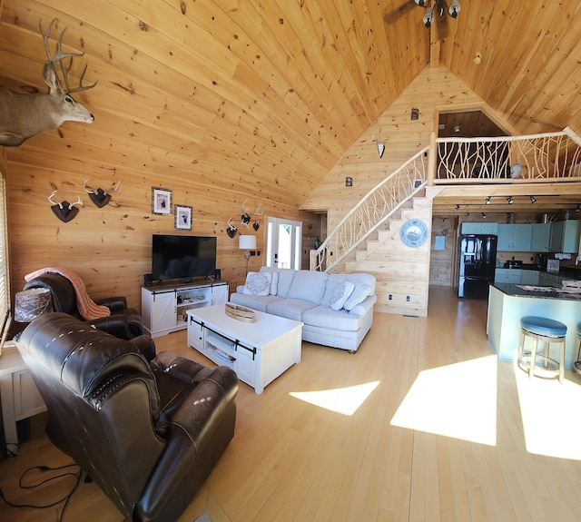 67 Upper Narrows Rd, Long Pond Twp, ME 04945 - living room featuring wood ceiling, stairs, wood walls, wood finished floors, and high vaulted ceiling
