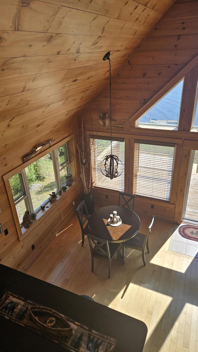 67 Upper Narrows Rd, Long Pond Twp, ME 04945 - dining room featuring wood ceiling, hardwood / wood-style flooring, wood walls, and high vaulted ceiling