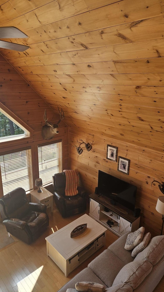 67 Upper Narrows Rd, Long Pond Twp, ME 04945 - living room with plenty of natural light, wooden walls, wood finished floors, vaulted ceiling, and wooden ceiling