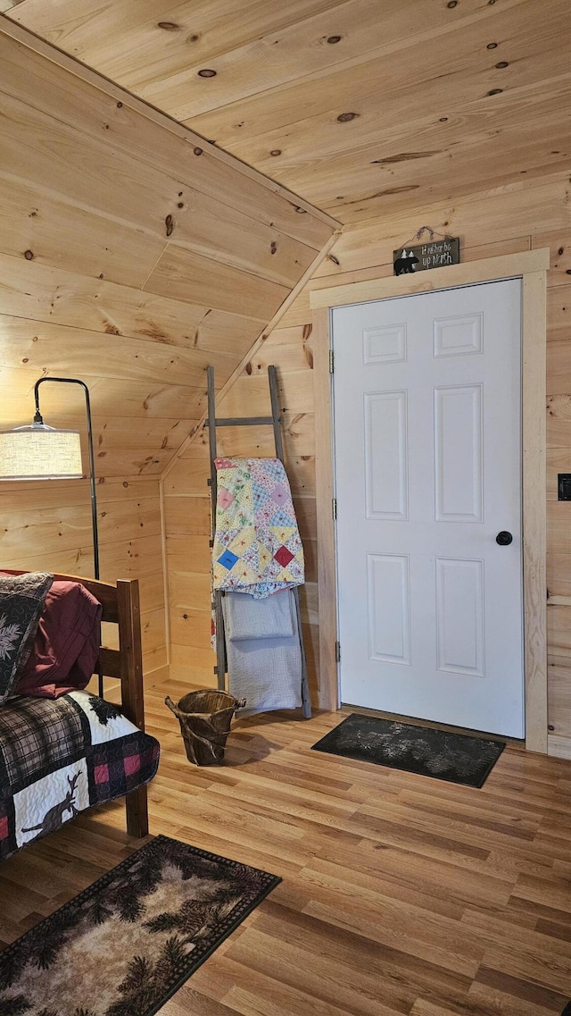 67 Upper Narrows Rd, Long Pond Twp, ME 04945 - foyer entrance with wooden walls, wood finished floors, vaulted ceiling, and wooden ceiling