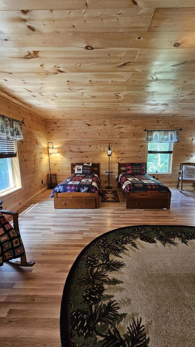 67 Upper Narrows Rd, Long Pond Twp, ME 04945 - bedroom with wood finished floors, wood walls, and wood ceiling