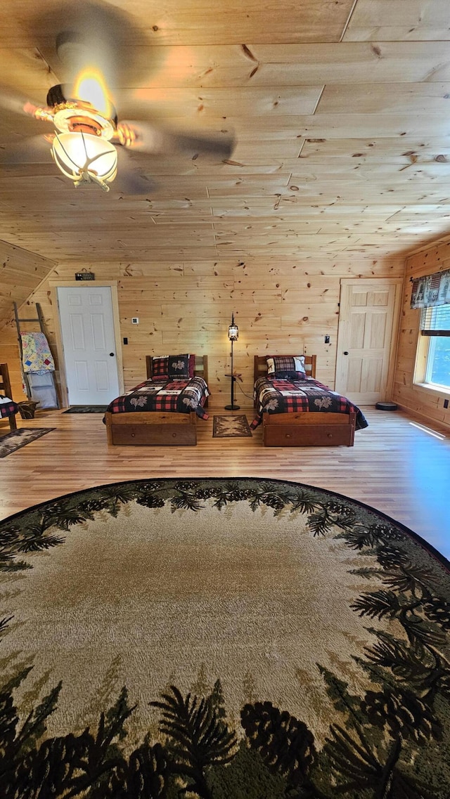 67 Upper Narrows Rd, Long Pond Twp, ME 04945 - bedroom with wood finished floors and wooden walls