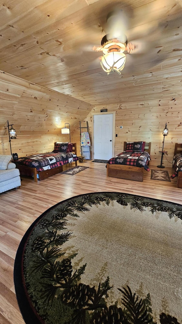 67 Upper Narrows Rd, Long Pond Twp, ME 04945 - bedroom with wood finished floors, wood walls, vaulted ceiling, and wood ceiling