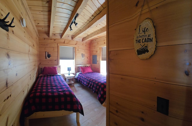 67 Upper Narrows Rd, Long Pond Twp, ME 04945 - bedroom with a wood ceiling with exposed beams, hardwood / wood-style flooring, wood walls, electric panel, and rail lighting