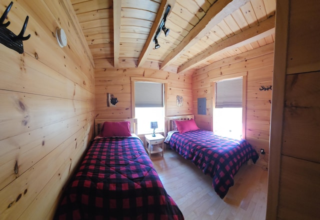 67 Upper Narrows Rd, Long Pond Twp, ME 04945 - bedroom featuring wood finished floors, wood walls, a wood ceiling with exposed beams, and electric panel