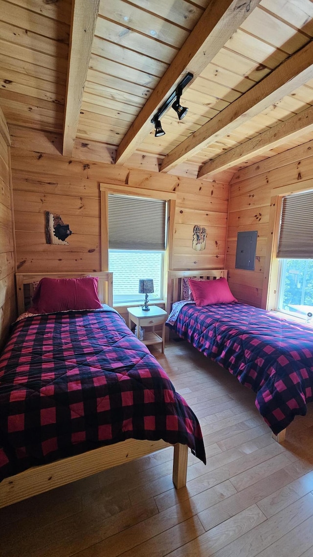67 Upper Narrows Rd, Long Pond Twp, ME 04945 - bedroom featuring wood walls, hardwood / wood-style flooring, and a wooden ceiling with exposed beams