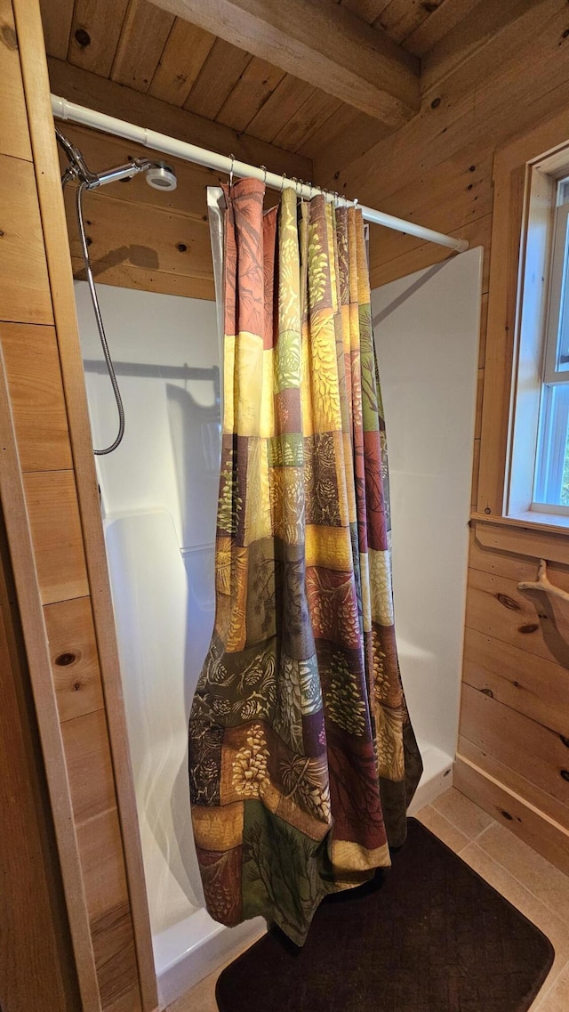 67 Upper Narrows Rd, Long Pond Twp, ME 04945 - bathroom with a stall shower, a wooden ceiling with exposed beams, wood walls, and tile patterned floors