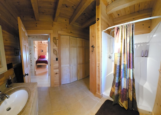 67 Upper Narrows Rd, Long Pond Twp, ME 04945 - bathroom with curtained shower, tile patterned flooring, a wooden ceiling with exposed beams, vanity, and wooden walls