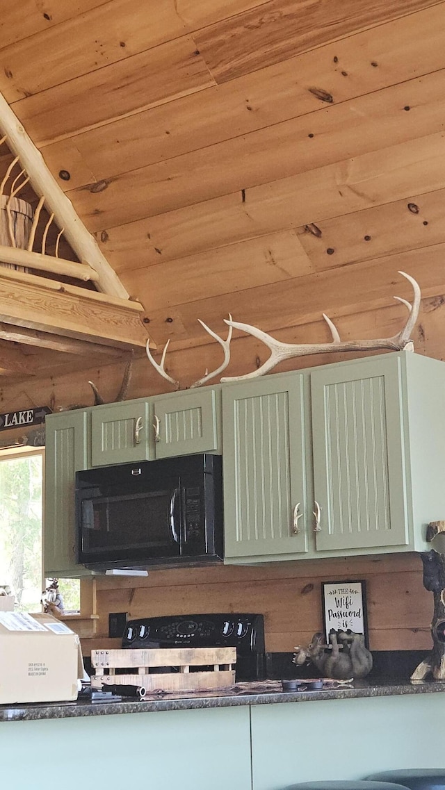 67 Upper Narrows Rd, Long Pond Twp, ME 04945 - kitchen with black microwave, wooden ceiling, dark countertops, and stove