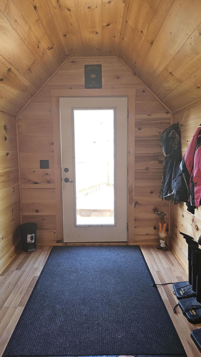67 Upper Narrows Rd, Long Pond Twp, ME 04945 - doorway with wooden walls, wood finished floors, vaulted ceiling, and wooden ceiling