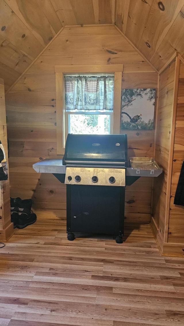 67 Upper Narrows Rd, Long Pond Twp, ME 04945 - kitchen featuring lofted ceiling, wooden ceiling, wooden walls, and light wood-style floors