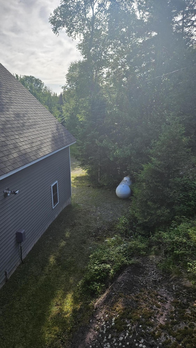 67 Upper Narrows Rd, Long Pond Twp, ME 04945 - view of side of property featuring roof with shingles