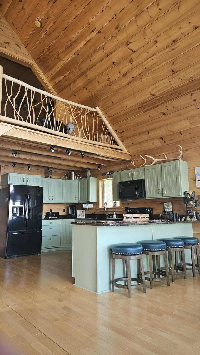 67 Upper Narrows Rd, Long Pond Twp, ME 04945 - kitchen with black appliances, green cabinetry, dark countertops, wood ceiling, and lofted ceiling