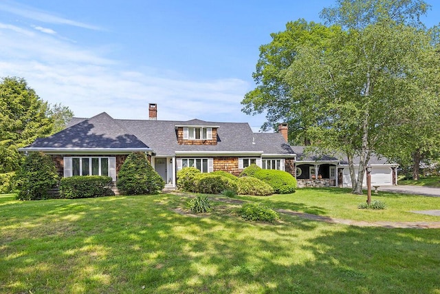 555 Pool St, Biddeford, ME 04005 - shingle-style home featuring a chimney, a front yard, driveway, and an attached garage