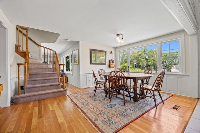 555 Pool St, Biddeford, ME 04005 - dining room with stairs, wood finished floors, and wainscoting