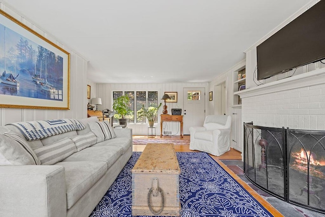 555 Pool St, Biddeford, ME 04005 - living area featuring wood finished floors, a fireplace, and built in features