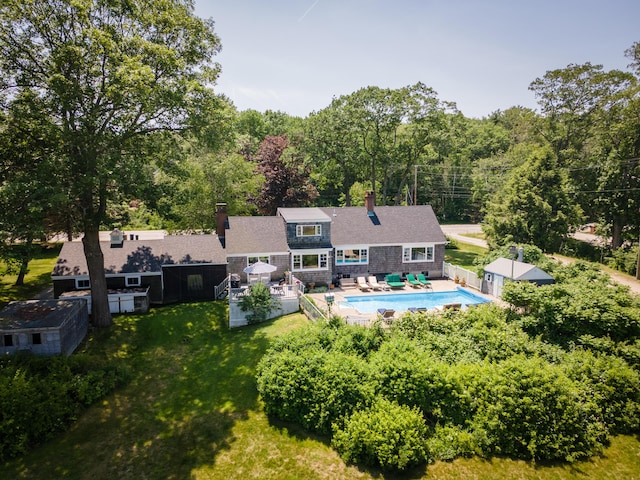 555 Pool St, Biddeford, ME 04005 - rear view of property with a chimney, an outdoor pool, a fenced backyard, and a patio