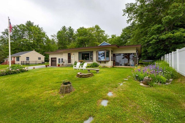 1522 Richville Rd, Standish, ME 04084 - back of house featuring an outdoor fire pit and an attached garage