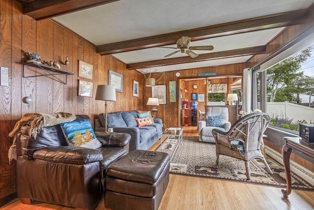1522 Richville Rd, Standish, ME 04084 - living area featuring wooden walls, a ceiling fan, wood finished floors, and beam ceiling
