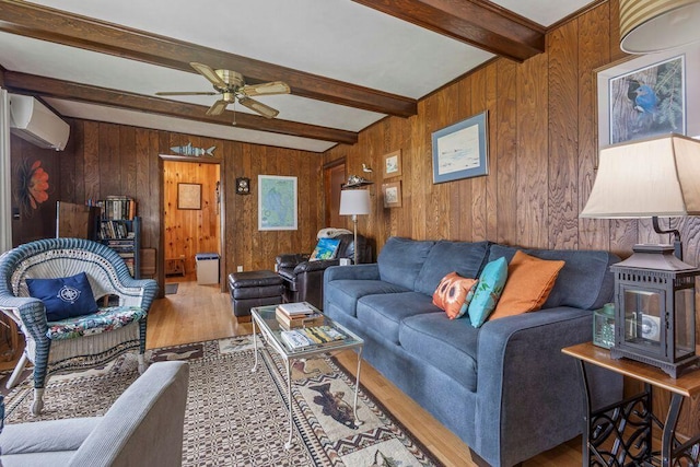 1522 Richville Rd, Standish, ME 04084 - living room with wood finished floors, beamed ceiling, a wall unit AC, a ceiling fan, and wooden walls