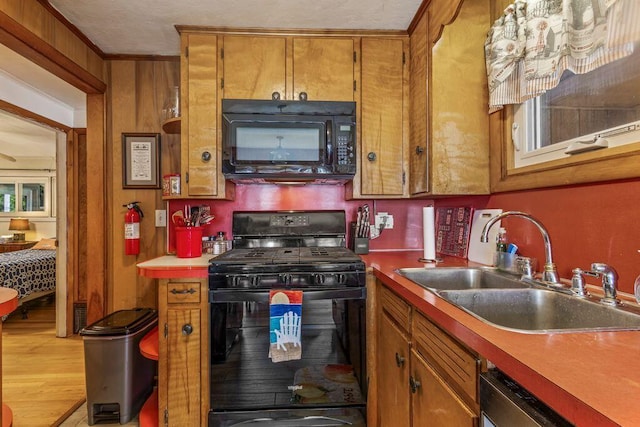 1522 Richville Rd, Standish, ME 04084 - kitchen with black appliances, brown cabinetry, light wood-style flooring, and light countertops