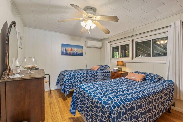 1522 Richville Rd, Standish, ME 04084 - bedroom with a wall mounted air conditioner, wood-type flooring, and ceiling fan