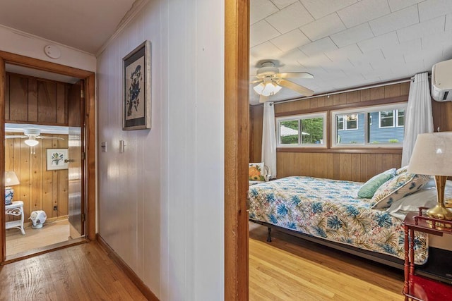 1522 Richville Rd, Standish, ME 04084 - bedroom with wood finished floors, crown molding, wood walls, and an AC wall unit