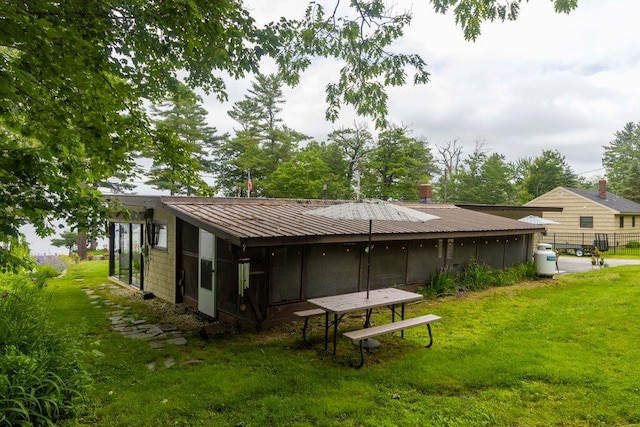 1522 Richville Rd, Standish, ME 04084 - back of property with a sunroom and a metal roof