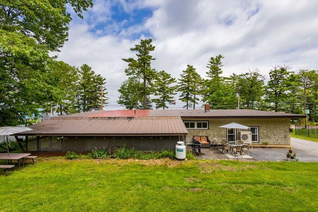 1522 Richville Rd, Standish, ME 04084 - rear view of house featuring a yard, a patio, a chimney, and a metal roof