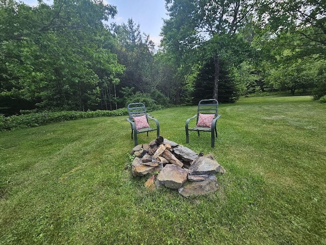 28 Varnum Pond Rd, Temple, ME 04984 - view of green lawn with an outdoor fire pit and a view of trees
