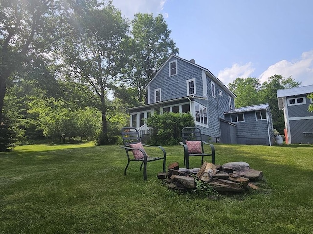 28 Varnum Pond Rd, Temple, ME 04984 - back of property with a yard and a standing seam roof