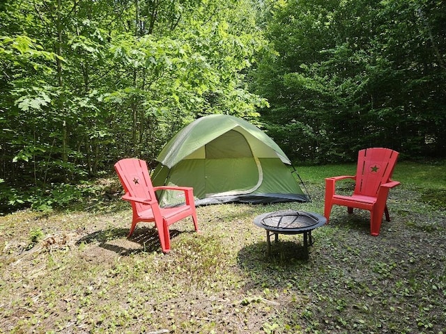 28 Varnum Pond Rd, Temple, ME 04984 - view of yard featuring an outdoor fire pit and a view of trees
