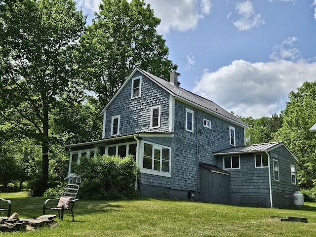 28 Varnum Pond Rd, Temple, ME 04984 - back of property featuring a standing seam roof, a metal roof, a chimney, and a yard