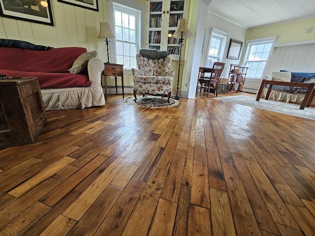 28 Varnum Pond Rd, Temple, ME 04984 - living room featuring hardwood / wood-style flooring, baseboard heating, and wood walls