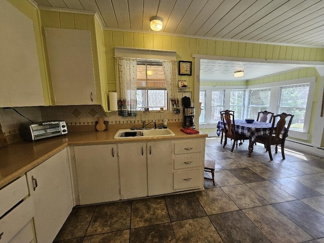 28 Varnum Pond Rd, Temple, ME 04984 - kitchen with tasteful backsplash, dark stone finish floors, wooden walls, and wood ceiling