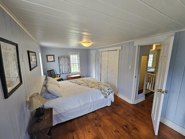 28 Varnum Pond Rd, Temple, ME 04984 - bedroom with hardwood / wood-style floors, crown molding, wood walls, and multiple closets