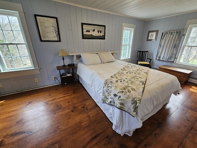 28 Varnum Pond Rd, Temple, ME 04984 - bedroom featuring ornamental molding, multiple windows, hardwood / wood-style floors, and wood walls