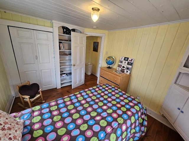 28 Varnum Pond Rd, Temple, ME 04984 - bedroom featuring dark wood-style flooring, a closet, wooden ceiling, and wood walls