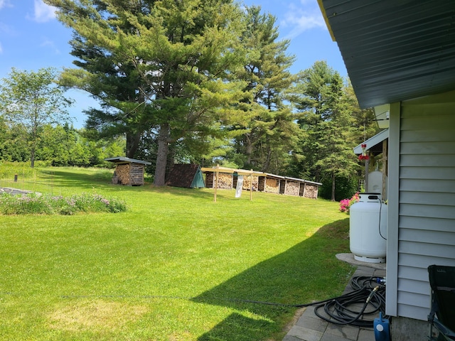 163 Ayer Ridge Rd, Freedom, ME 04941 - view of green lawn featuring a shed and view of wooded area